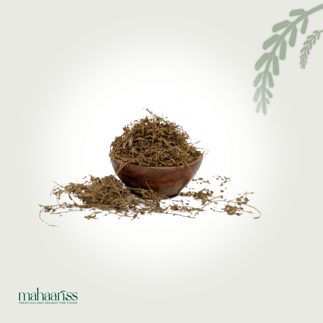 Whole dried Bhringaraj herb in a wooden bowl, natural organic superfood