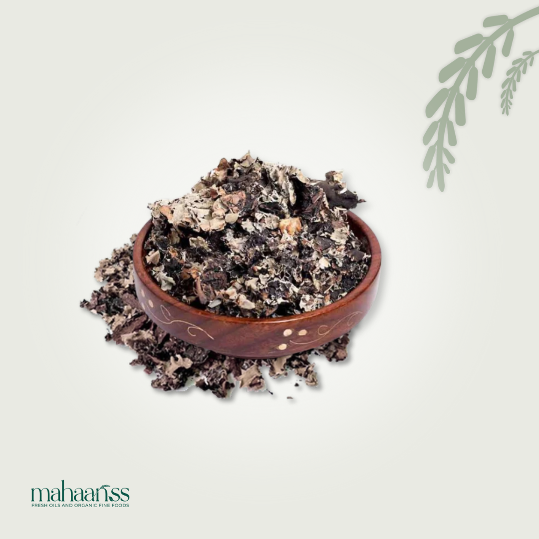 Wooden bowl filled with dark brown organic material on a light background, with 'maharajiss' branding.