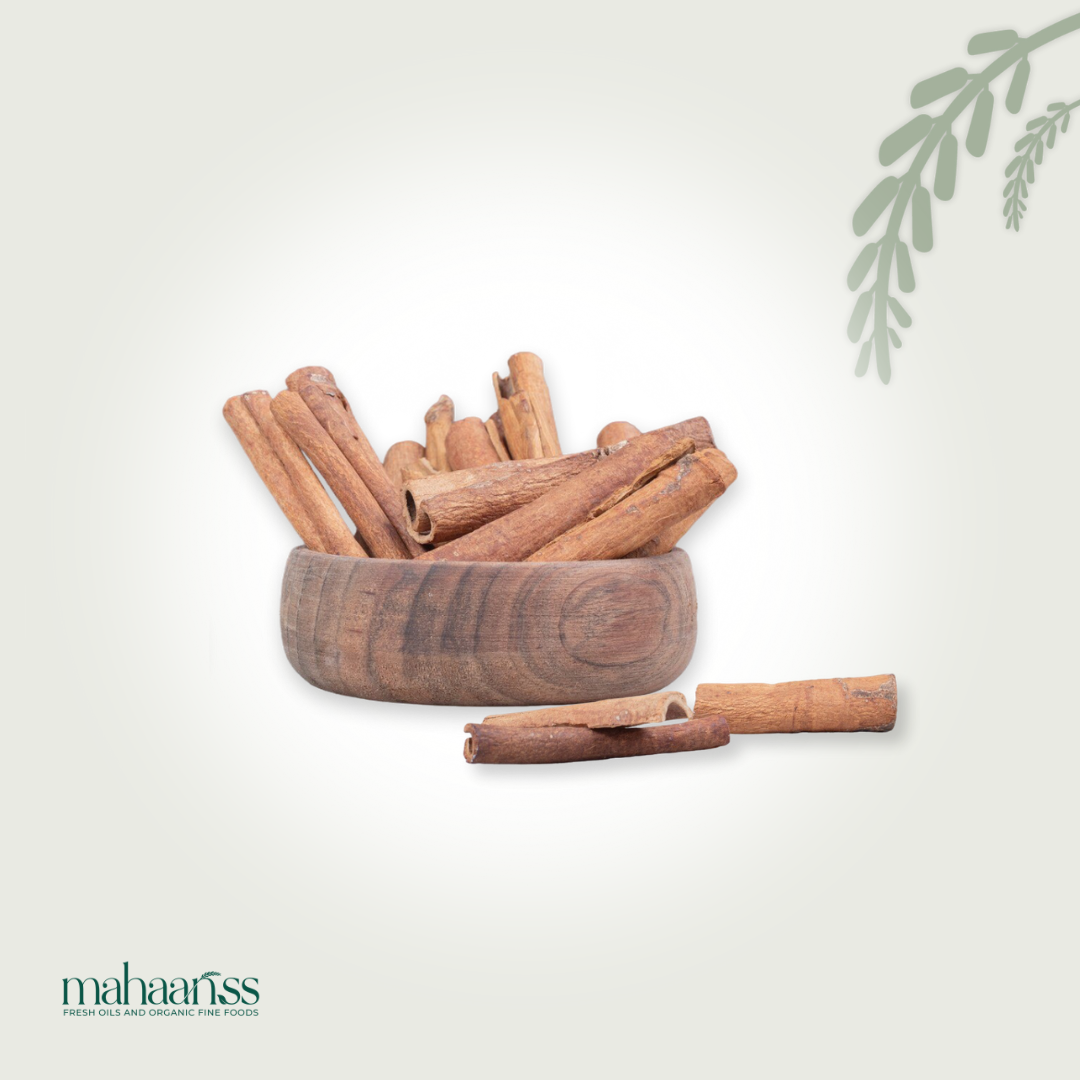 Natural Ceylon cinnamon sticks in a wooden bowl on a light background, organic spice