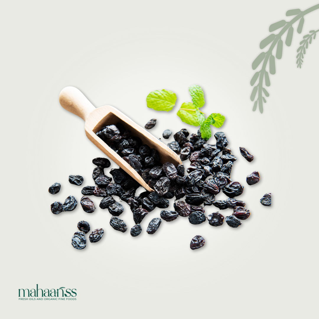 Wooden scoop with raisins and mint leaves on a light background, featuring the brand 'mahaaaris'.