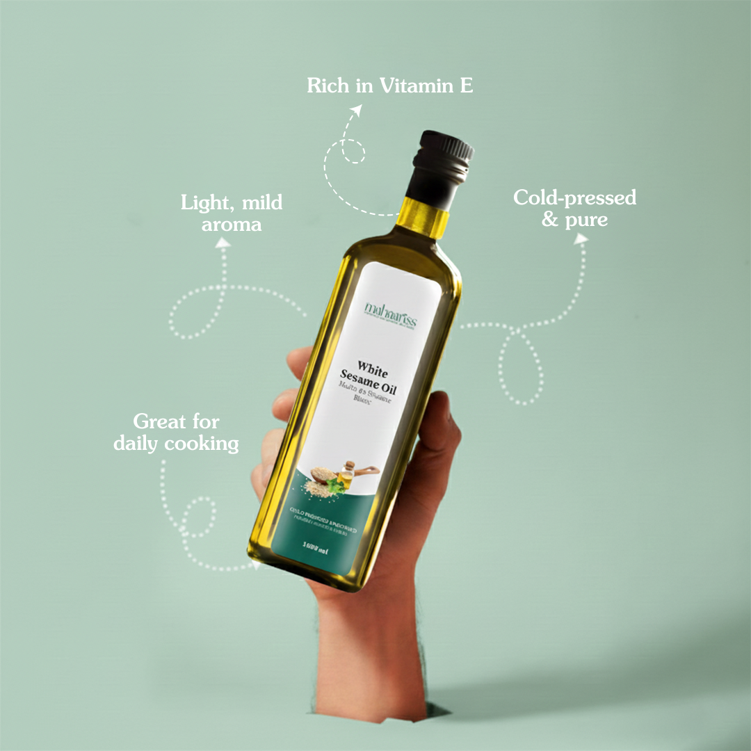 Bottle of white sesame oil held by a hand with text highlighting its properties on a light green background