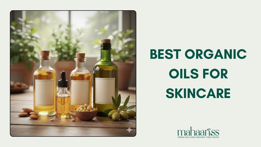Three glass bottles of various organic oils for skincare, including one with a dropper and another larger bottle next to a bowl of soybeans, almonds, and olive branches. The text overlay reads "BEST ORGANIC OILS FOR SKINCARE."