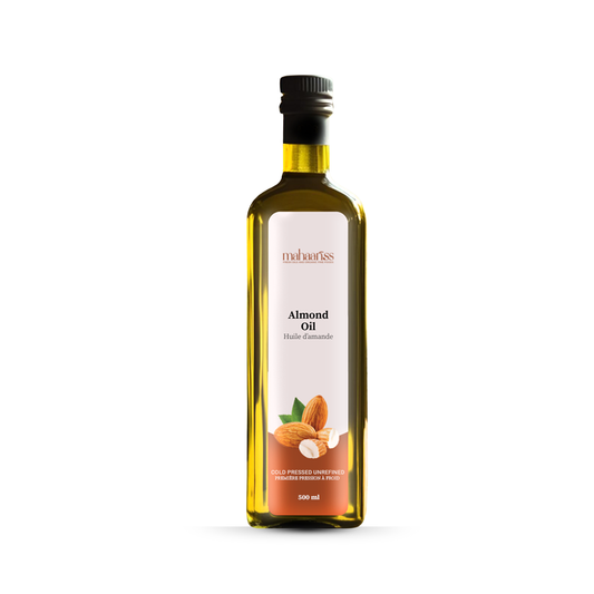 Bottle of almond oil with a label on a white background