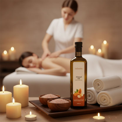 Almond oil bottle on a tray with candles and towels in the background of a massage setting