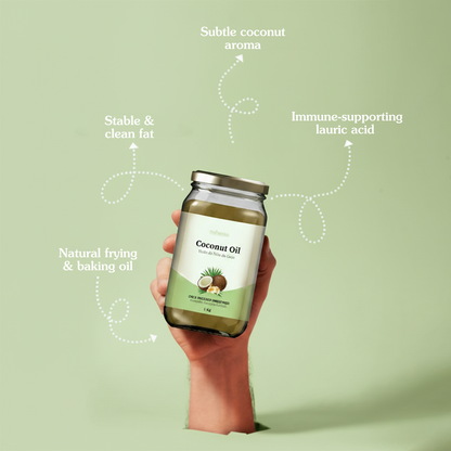 Coconut oil bottle held by a hand with text highlighting benefits on a light green background