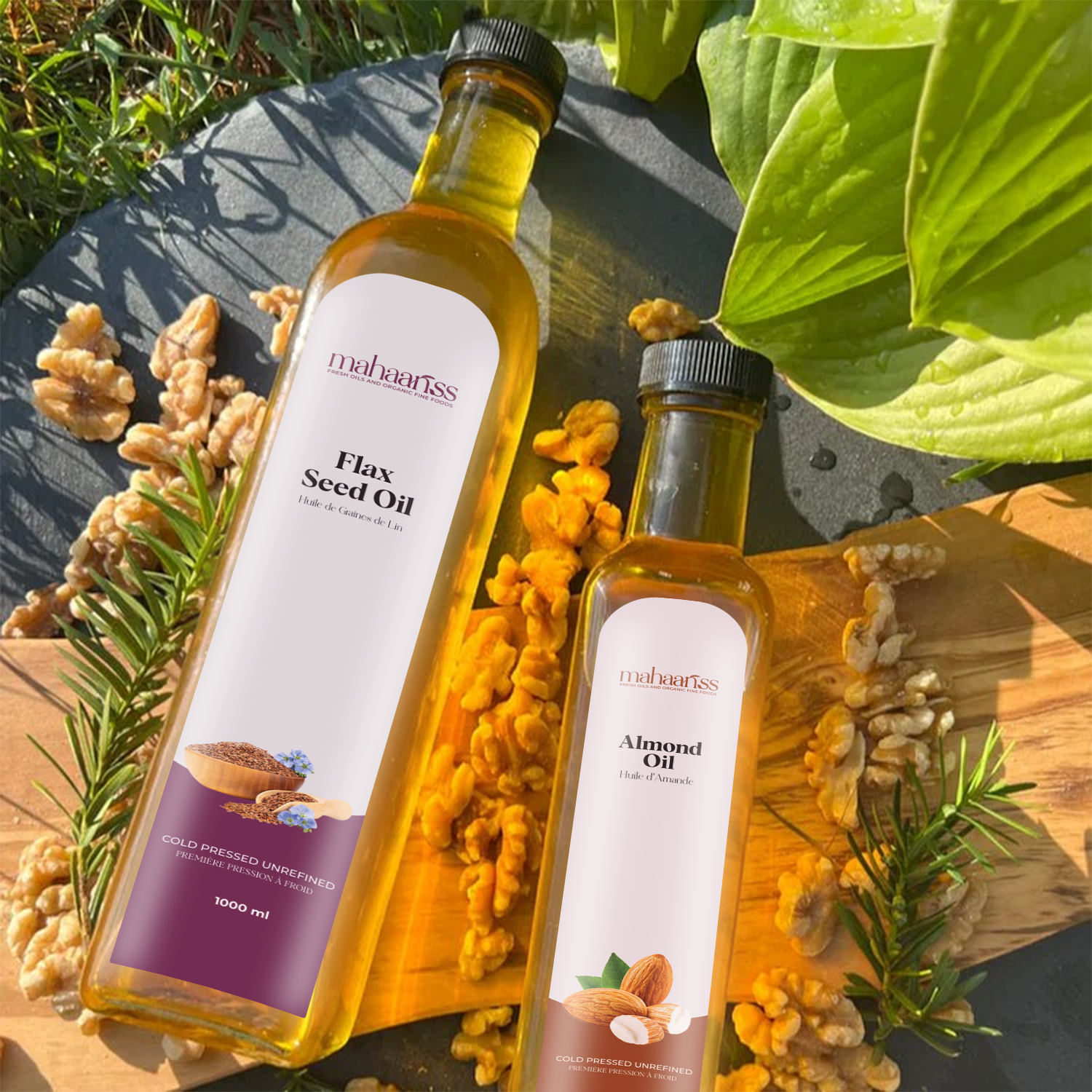 Two bottles of oil, one labeled 'Flax Seed Oil' and the other 'Almond Oil', surrounded by nuts and herbs on a wooden surface.