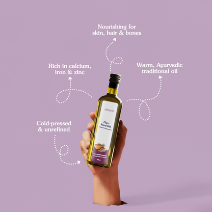 Bottle of Infused Flax Seed Oil held by a hand on a purple background with text about the oil's benefits.