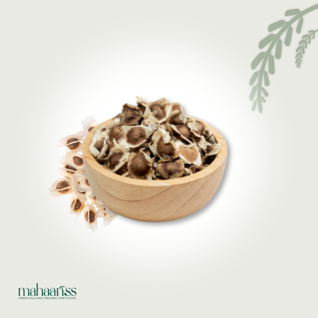 Natural moringa seeds with shells in a wooden bowl, organic superfood ingredient