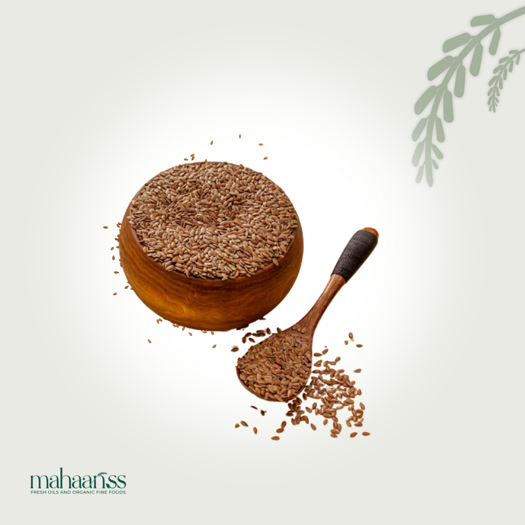 Organic flaxseeds in a wooden bowl with a wooden spoon on a light background