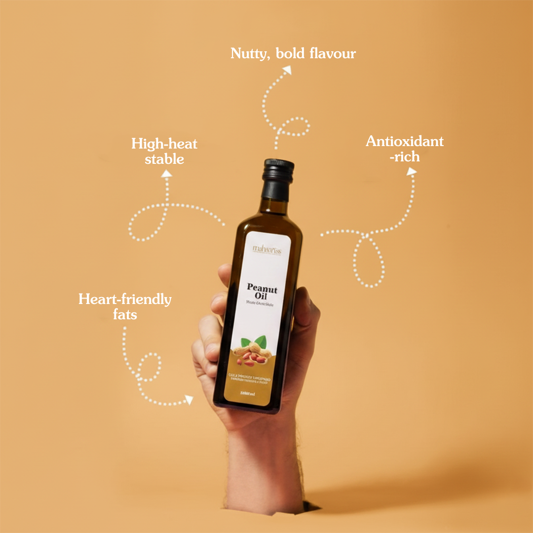 Hand holding a bottle of peanut oil with text highlighting its benefits on an orange background