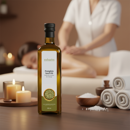 Bottle of pumpkin seed oil on a massage table with a blurred background of a massage session.